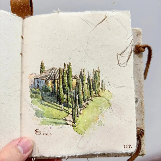 Watercolor landscape tutorial featuring a rustic villa surrounded by tall cypress trees, sunlight shadows, and soft green hills