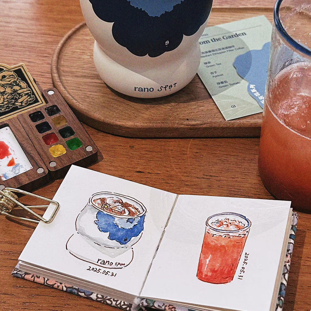 Portable watercolor kit with vibrant color pans, designed for compact creative work, held in a traveler's hand.